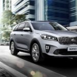 A silver 2019 Kia Sorento, popular with Kia lease deals, is driving in the city.