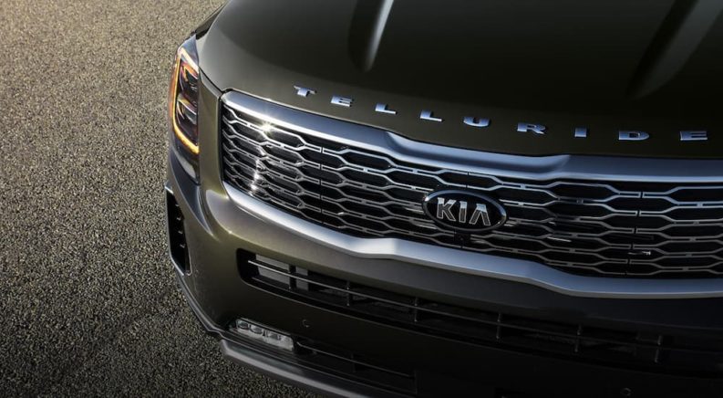 The front end of a green 2020 Kia Telluride is shown in a closeup.