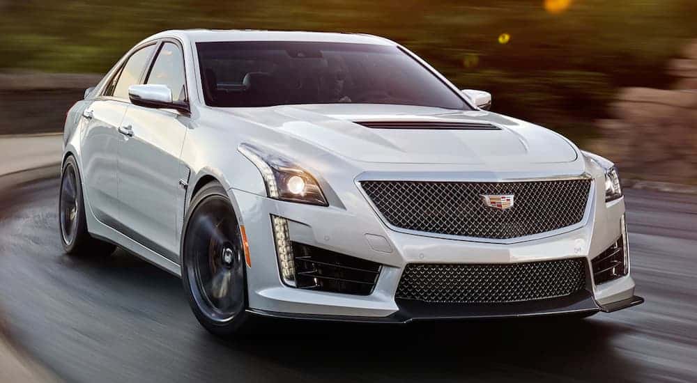 A white 2019 Cadillac CTS-V is driving around a corner.