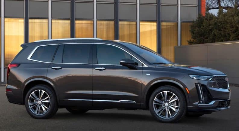 A dark grey 2020 Cadillac XT6 is parked outside one of the Cadillac dealers in Texas.