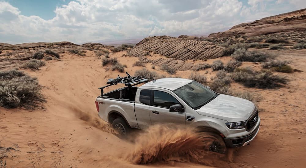 A silver 2019 Ford Ranger, which is popular among Ford trucks, is driving through the desert. 