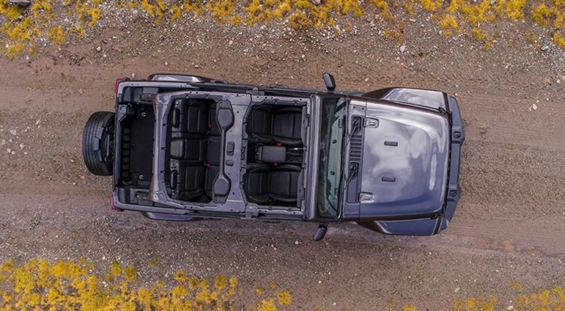 A birds eye view of a grey 2019 jeep Wrangler, popular among Jeeps for sale, is parked with no top and the doors are off.