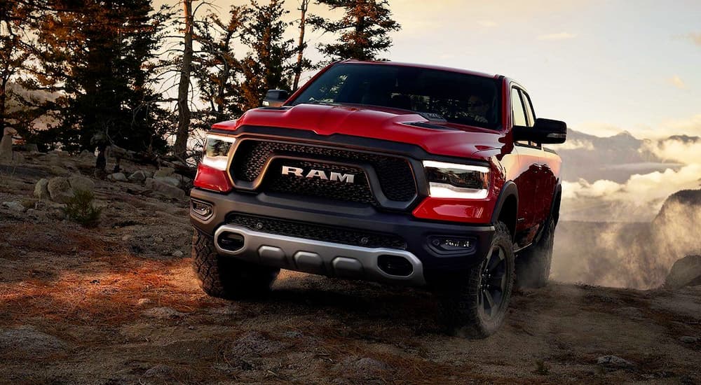 A red 2019 Ram Rebel is on a mountain trail.