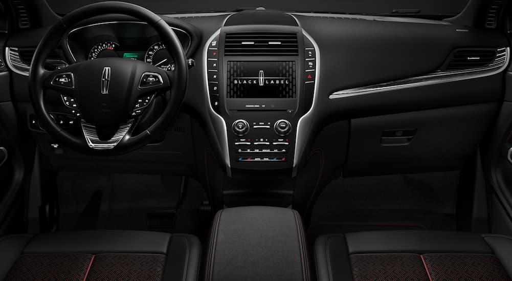The front black leather interior of a 2019 MKC Black Label Center Stage theme.