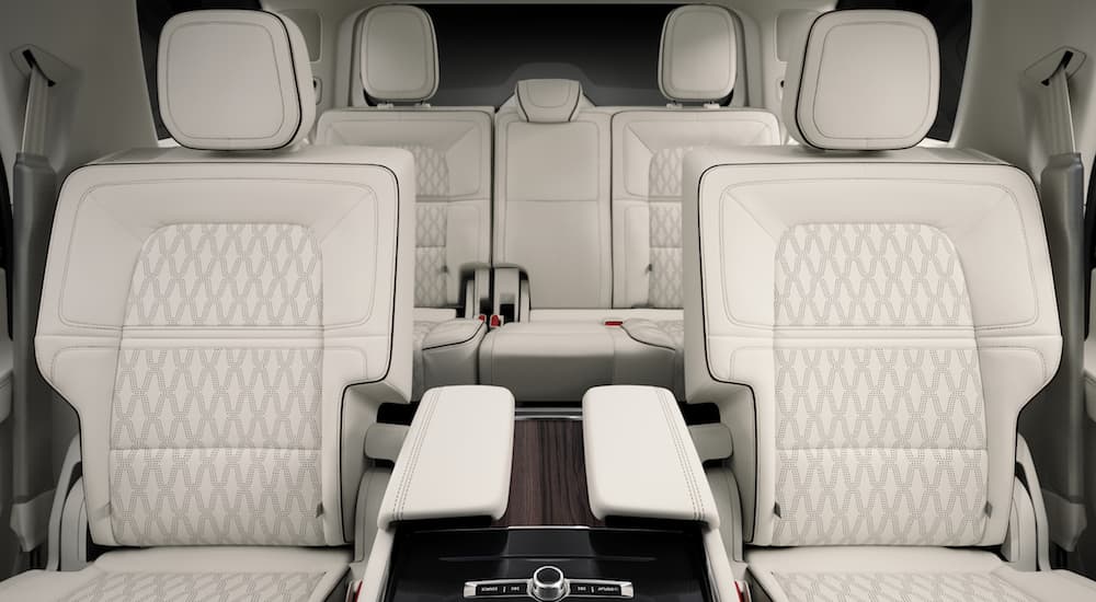 The front and rear white and black leather interior of the 2019 Black Label Navigator Chalet themed is shown. 