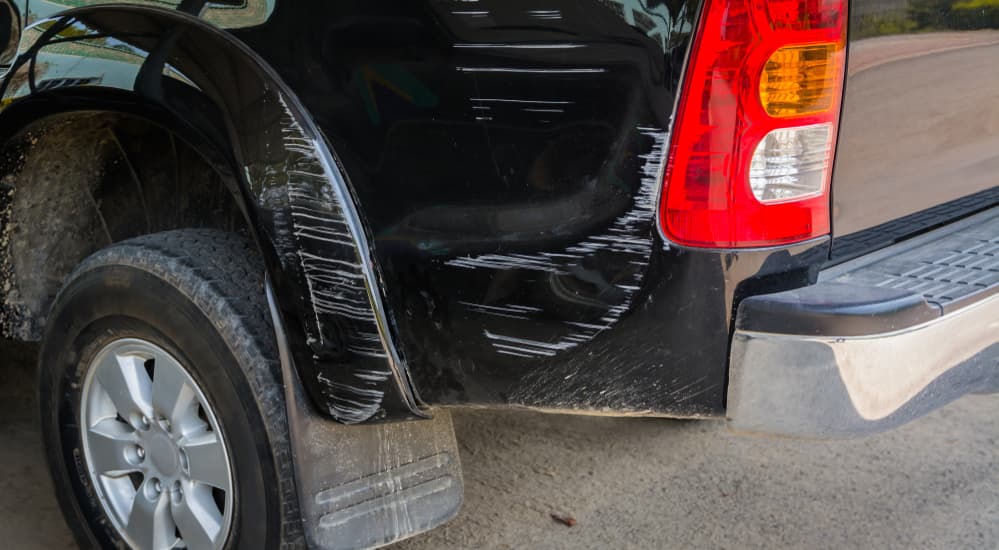 Scratches are shown on the side of a black truck.