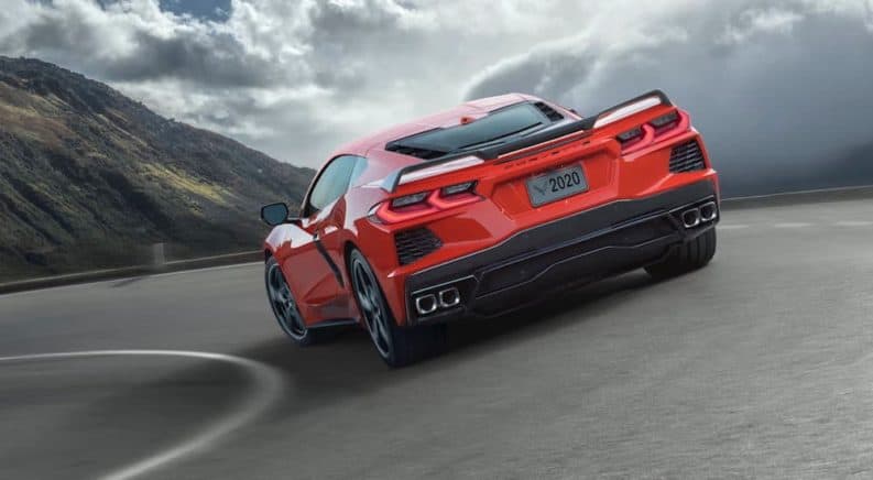 A red 2020 Chevy Corvette is driving around a corner.