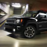 A black 2020 Jeep Renegade, which wins when comparing the 2020 Jeep Renegade vs the 2020 Hyundai Kona, is driving around a corner in a parking garage.