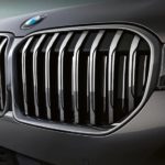 A close up of the front end of a grey BMW XS.