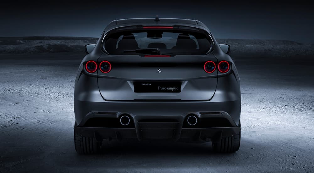 The rear end of the upcoming Ferrari Purosangue, which is a popular topic in current auto news, in the desert at night.
