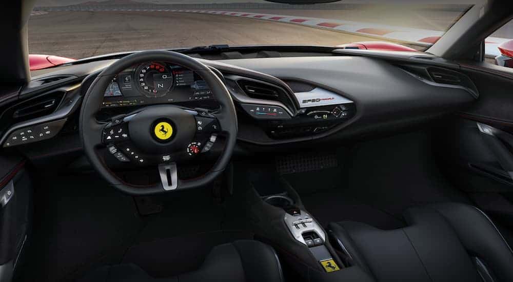 The front black leather interior of a 2020 Ferrari Stradale is shown. 