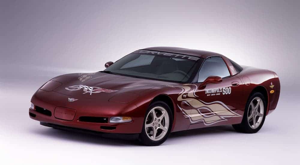 A red 2003 Chevy Corvette, which is a popular used Chevrolet model, has 50th Anniversary decals on it.