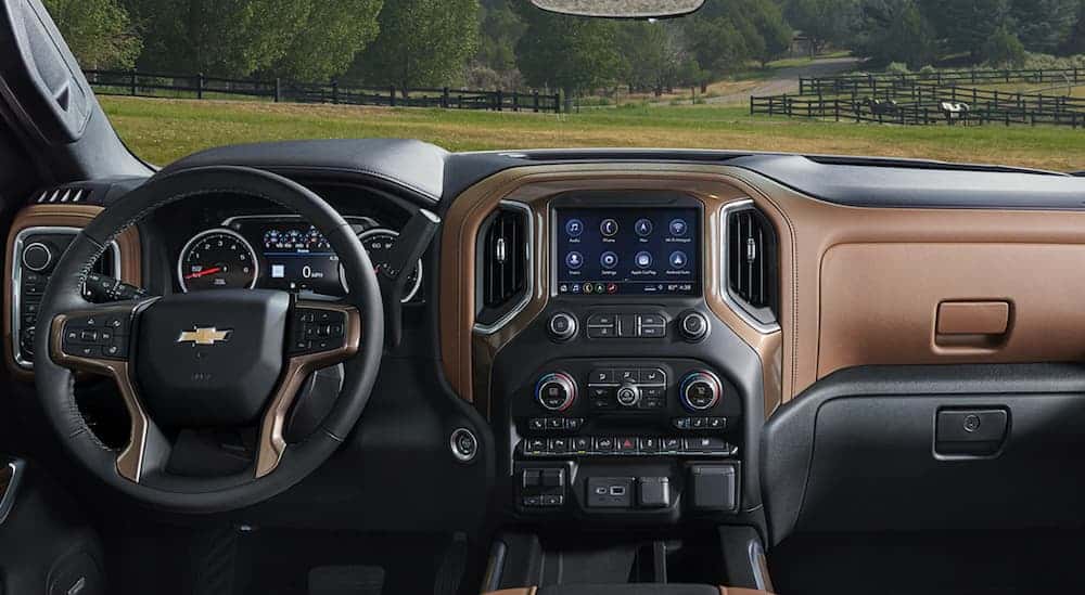 The front black and brown leather interior of a 2020 Chevy Silverado 1500 is shown. 