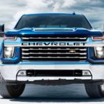 A blue 2020 Chevy Silverado 2500HD is facing forward while parked on a salt flat.