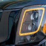 A close up is shown of the headlight on a black 2021 Kia Telluride Nightfall.
