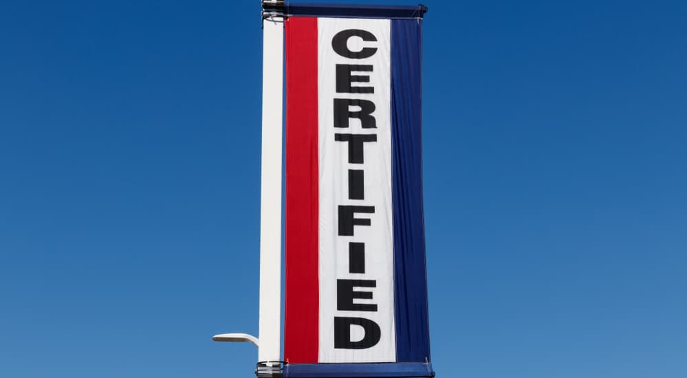 A red, white, and blue sign that says Certified is shown.