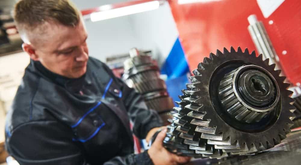 A mechanic is working on new gears for a lifted truck. 
