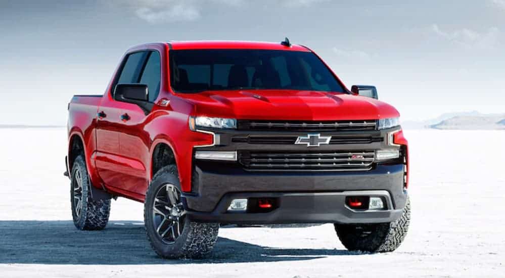 A red 2020 Chevy Silverado LT Trail Boss is parked on a flat salt land.
