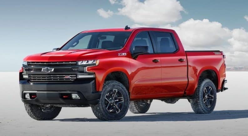 A red 2020 Chevy Silverado 1500 Trailboss is parked on a flat salt land.