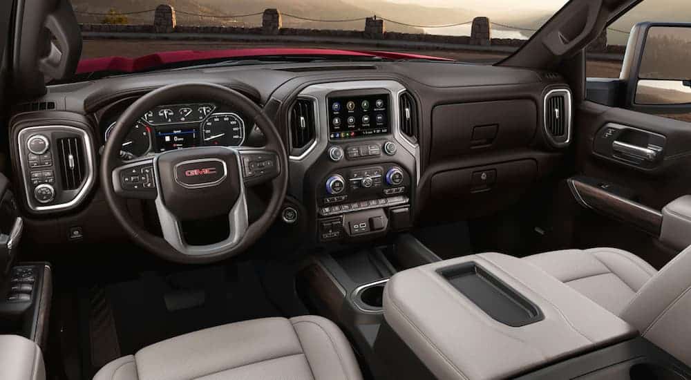 The brown and tan front leather interior of a 2020 GMC Sierra 2500HD is shown. 