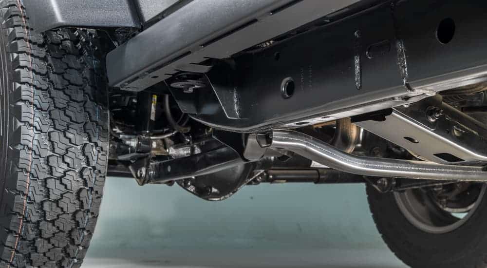 The undercarriage of a Jeep is shown.