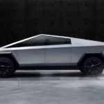 A side view of the Tesla Cybertruck is shown while parked in a dark lit garage.
