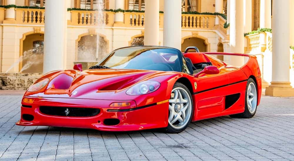 A red 1995 Ferrari F50 is parked in front of a large home. Image: Jorge A. Guasso ©2019 Courtesy of RM Sotheby's