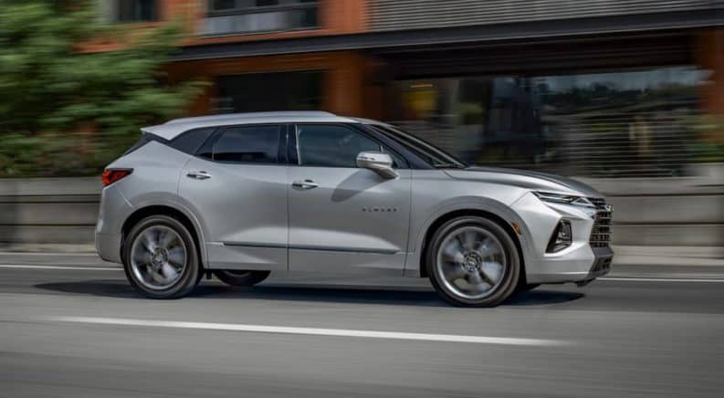 A silver 2020 Chevy Blazer is driving on a city street after winning the 2020 Chevy Blazer vs 2020 Ford Edge comparison.