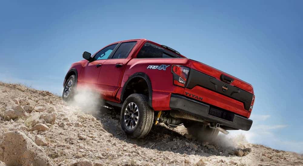 A red 2020 Nissan Titan Pro 4x is off-roading uphill.