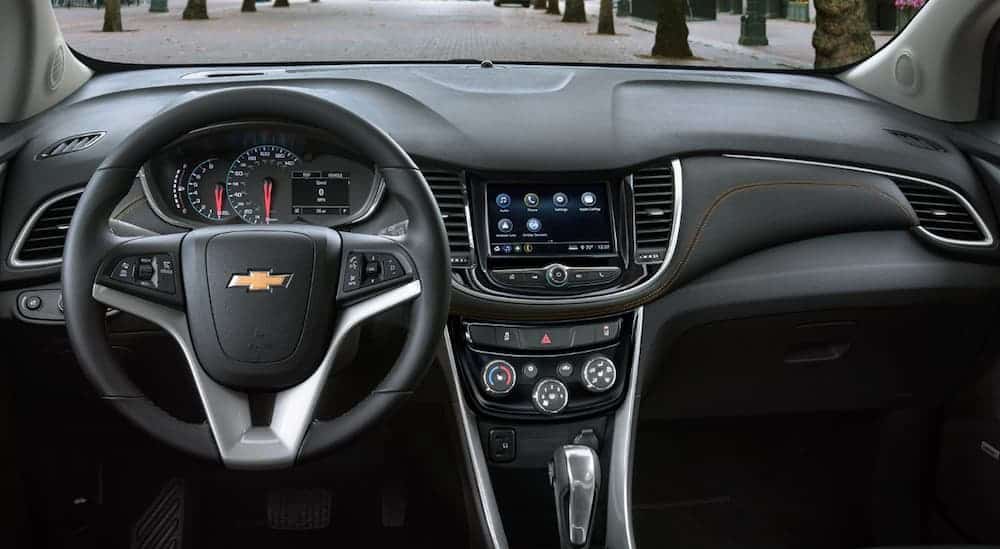 The front black leather interior of a 2020 Chevy Trax is shown. 