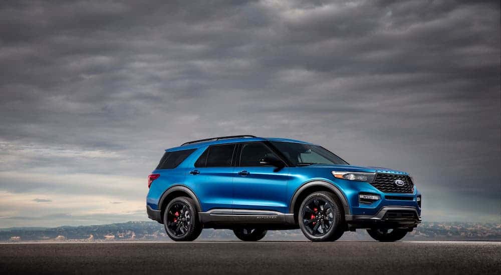 A blue Explorer is parked against gray clouds after winning 2020 Ford Explorer vs 2020 Kia Telluride.