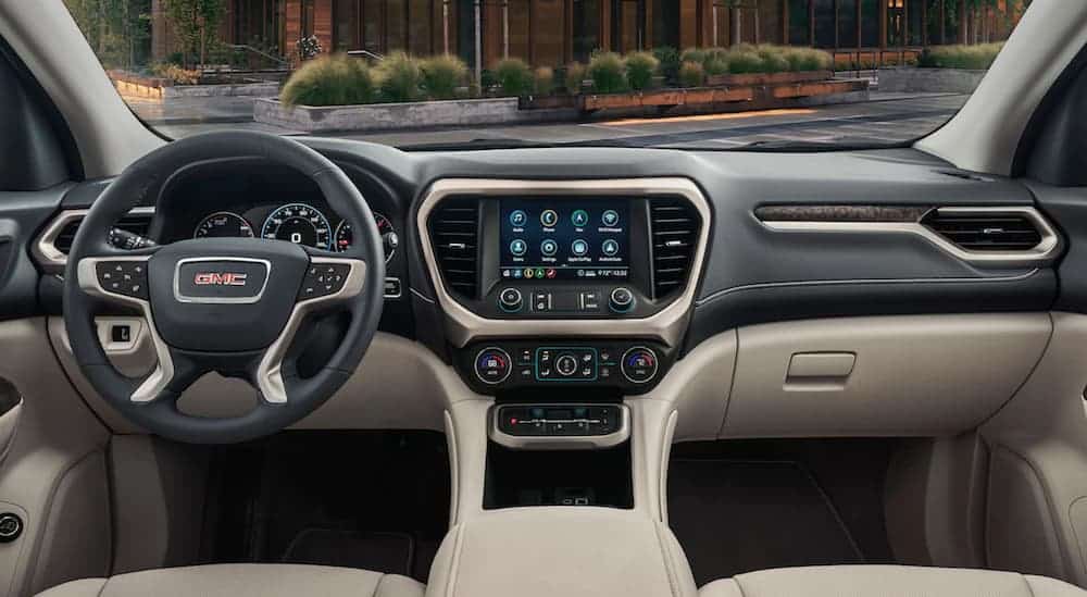 The front tan and black leather interior of a 2020 GMC Acadia is shown. 