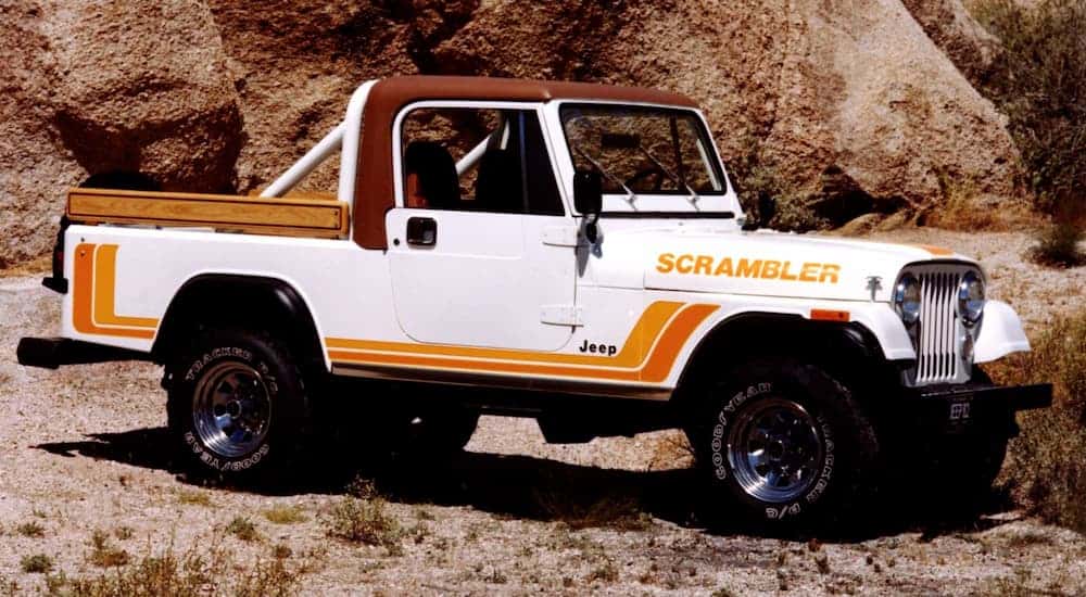 A 1982 Jeep CJ-8 Scrambler is parked in the desert.