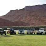 A lineup of historical Jeeps for sale are shown on the grass at Moab.