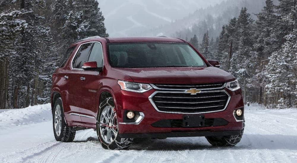 A red 2018 Chevy Traverse is parked on a snowy road.