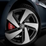 The wheel of a 2020 Volkswagen Golf GTI is shown in a dark room.