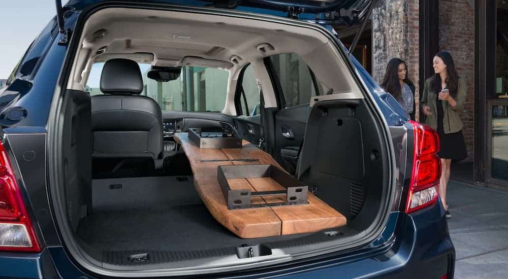 The cargo area of a blue 2020 Chevy Trax is shown with a table inside.