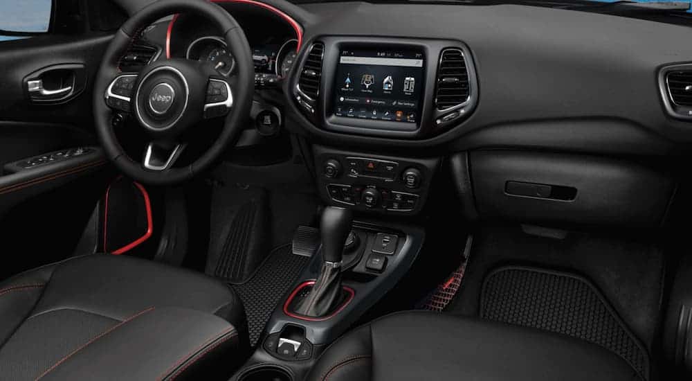 The black and red interior of a 2020 Jeep Compass is shown.