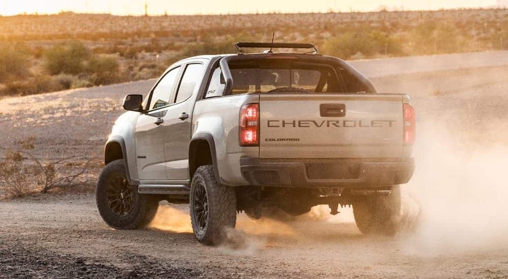 A tan 2021 Chevy Colorado is off-roading in a desert.