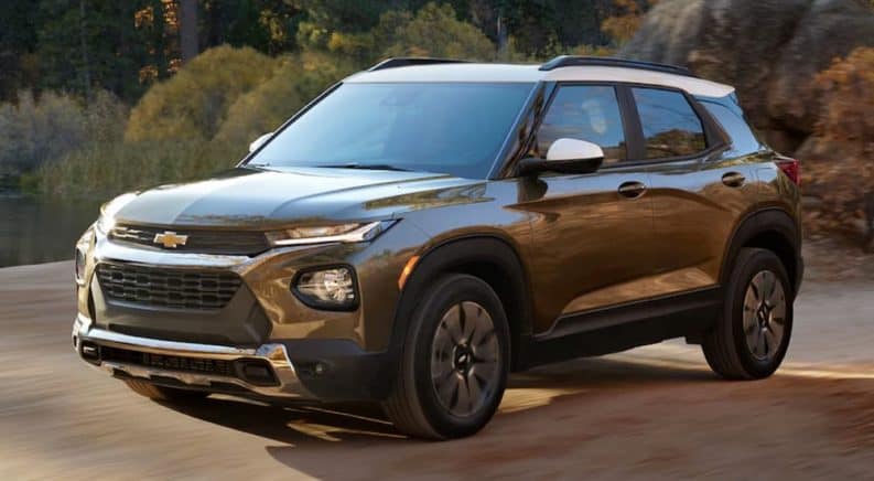 A brown 2021 Chevy Trailblazer is driving on a dirt road.