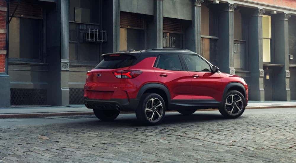 A red and black 2021 Chevy Trailblazer RS is parked on a cobblestone street.
