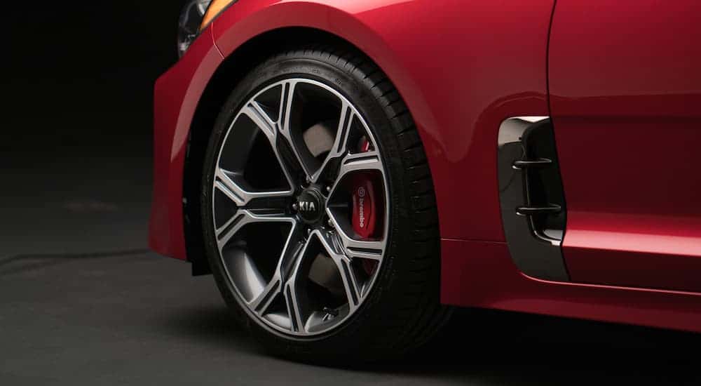 A close up is shown of the Brembo brakes on a red 2020 Kia Stinger.