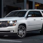 A white 2020 Chevy Tahoe is parked on a city street at night after leaving an Atlanta Chevy dealer.