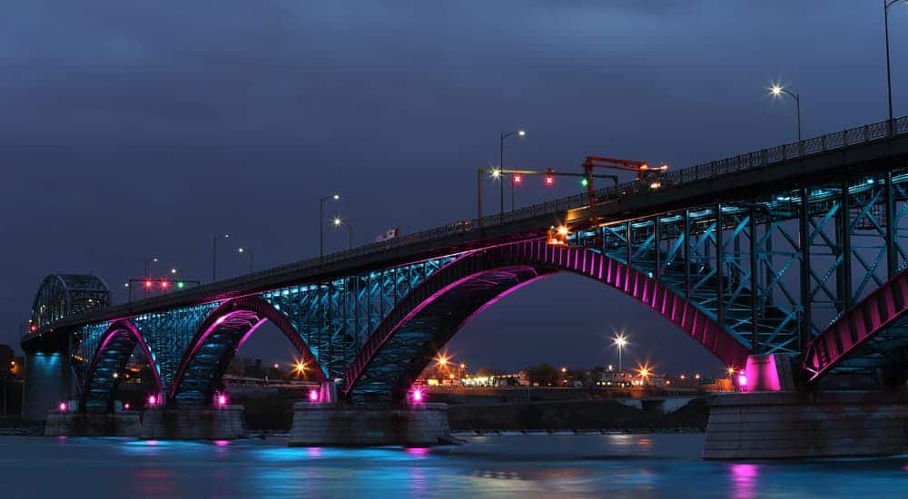The Peace Bridge in Buffalo, NY, is lit up at night.