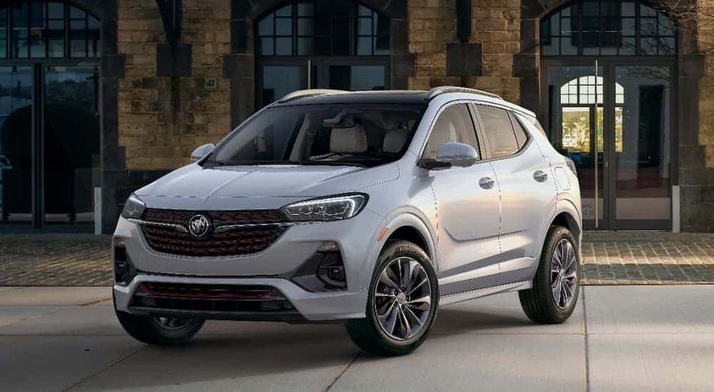 A silver 2020 Buick Encore GX is parked on a cobblestone alleyway.