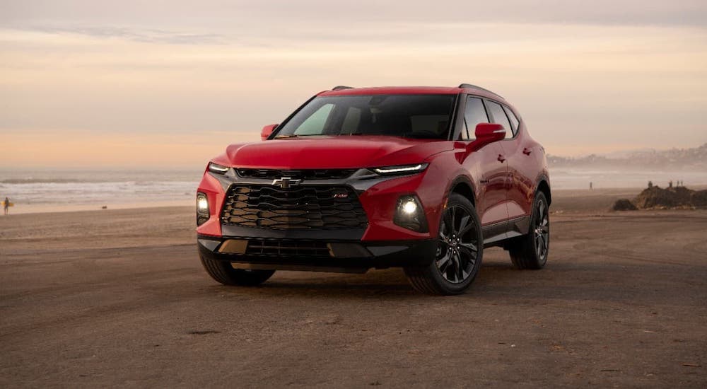 A red 2020 Chevy Blazer RS is parked on a beach at sunset after winning the 2020 Chevy Blazer vs 2020 Ford Edge comparison.