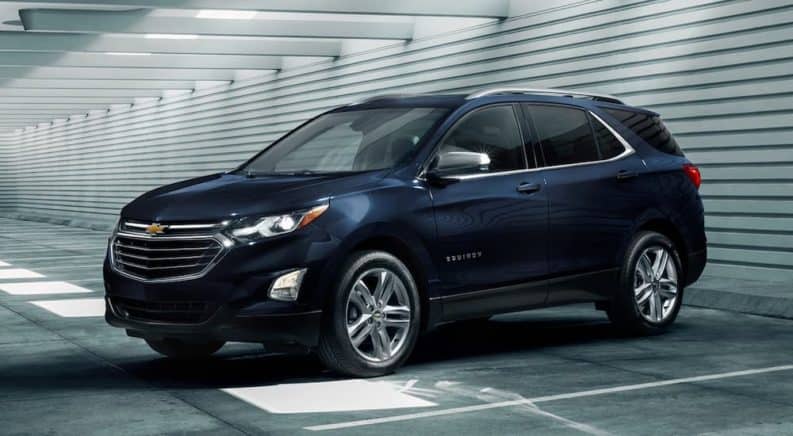 A blue 2020 Chevy Equinox is parked in a bright parking garage after winning the 2020 Chevy Equinox vs 2020 Nissan Rogue comparison.