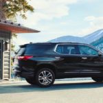 A black 2020 Chevy Traverse is parked in front of a snowy mountain.