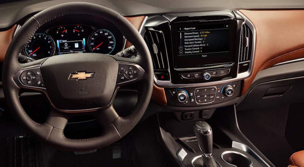 A look at the steering wheel and brown interior of a 2020 Chevy Traverse High Country, the winner of the 2020 Chevy Traverse vs 2020 Mazda CX-9 comparison.