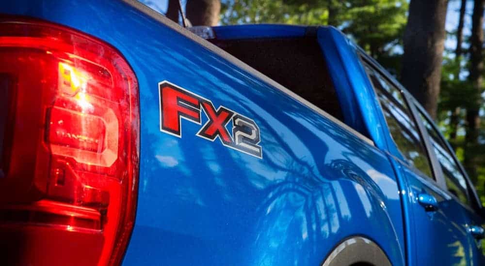 A closeup is shown of the FX2 badging on the rear of a Ranger, winner of the 2020 Ford Ranger vs 2020 Toyota Tacoma comparison.
